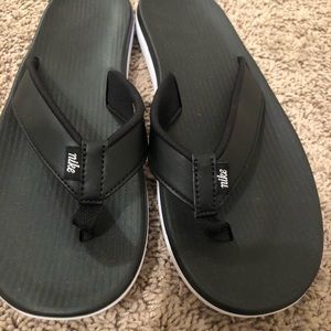 Women’s black Nike flip flops